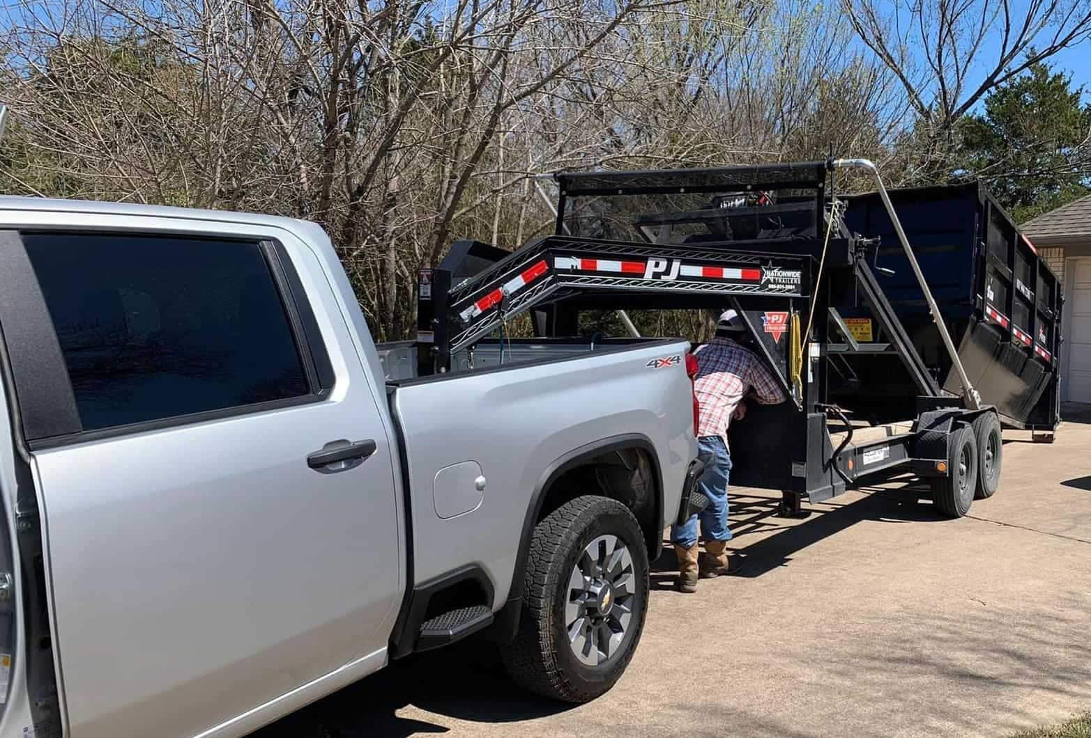 Benita's truck delivering a roll off dumpster